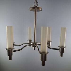 Close view of a six-arm chandelier in satin nickel with tall frosted glass tube shades