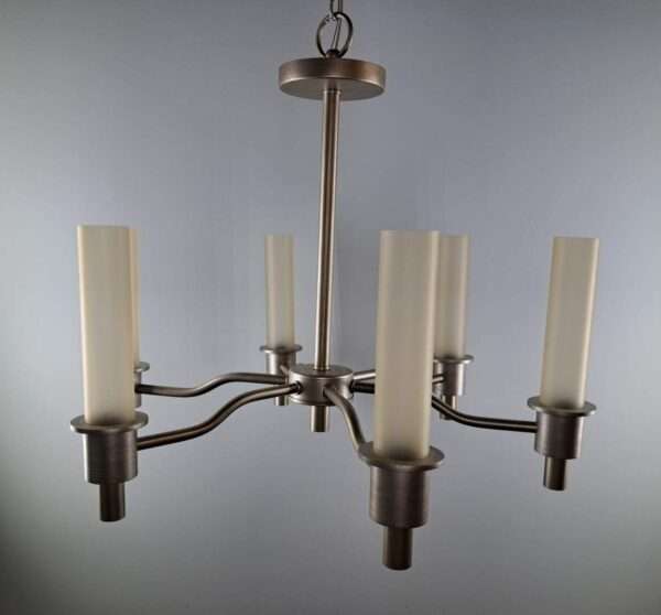 Close view of a six-arm chandelier in satin nickel with tall frosted glass tube shades