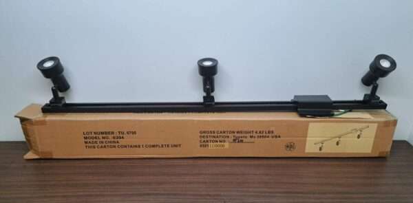Assembled 3-head LED track light fixture in matte black on packaging.